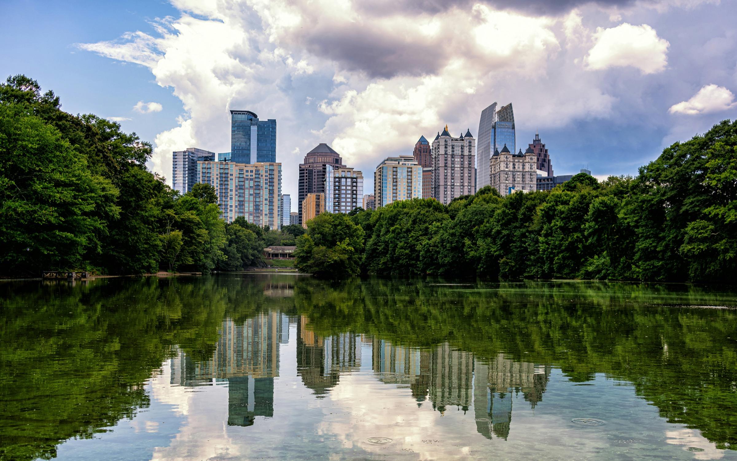 Atlanta skyline reflected in a lake bordered by trees