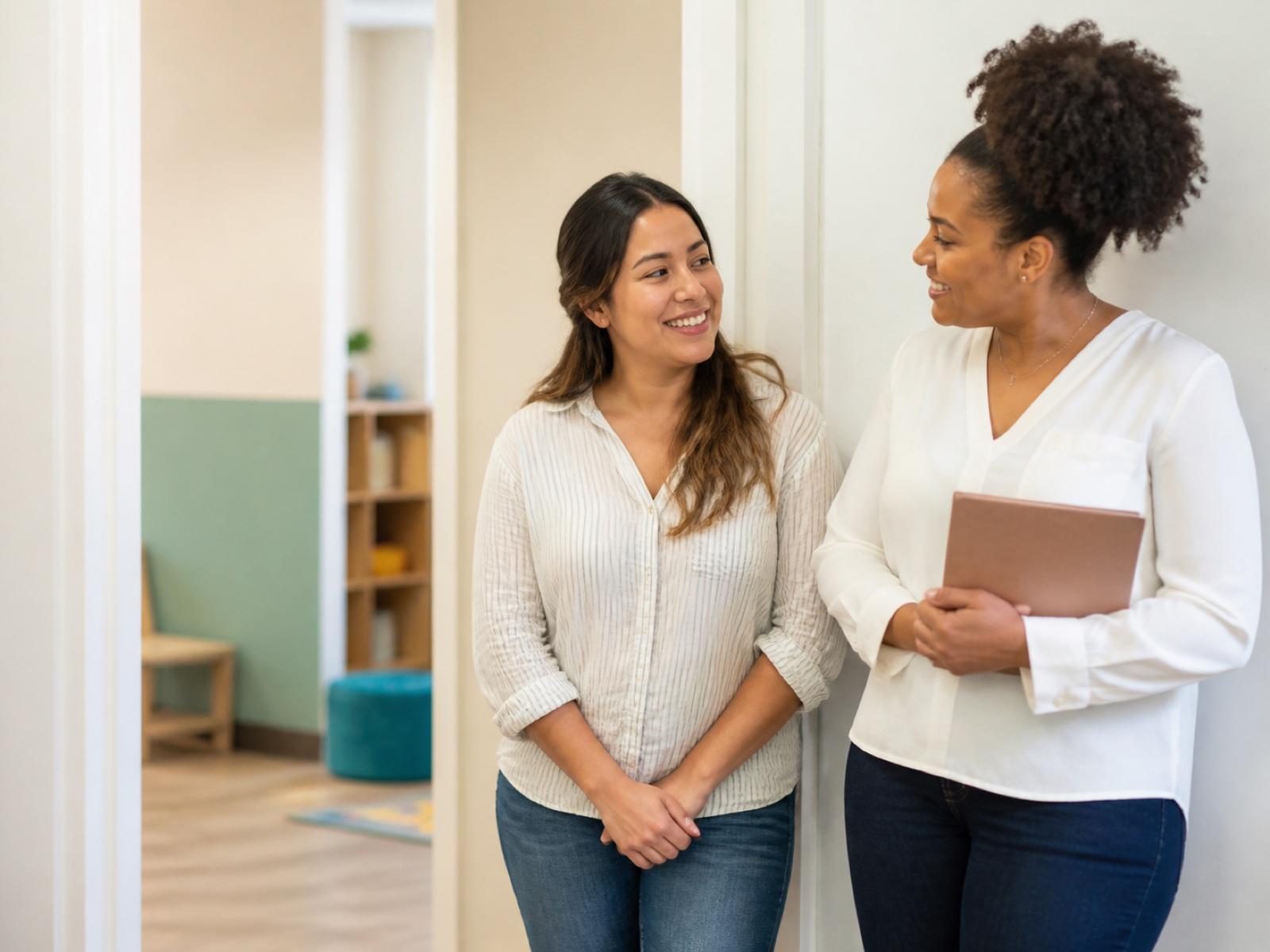 An RBT and BCBA sharing a supportive conversation at work